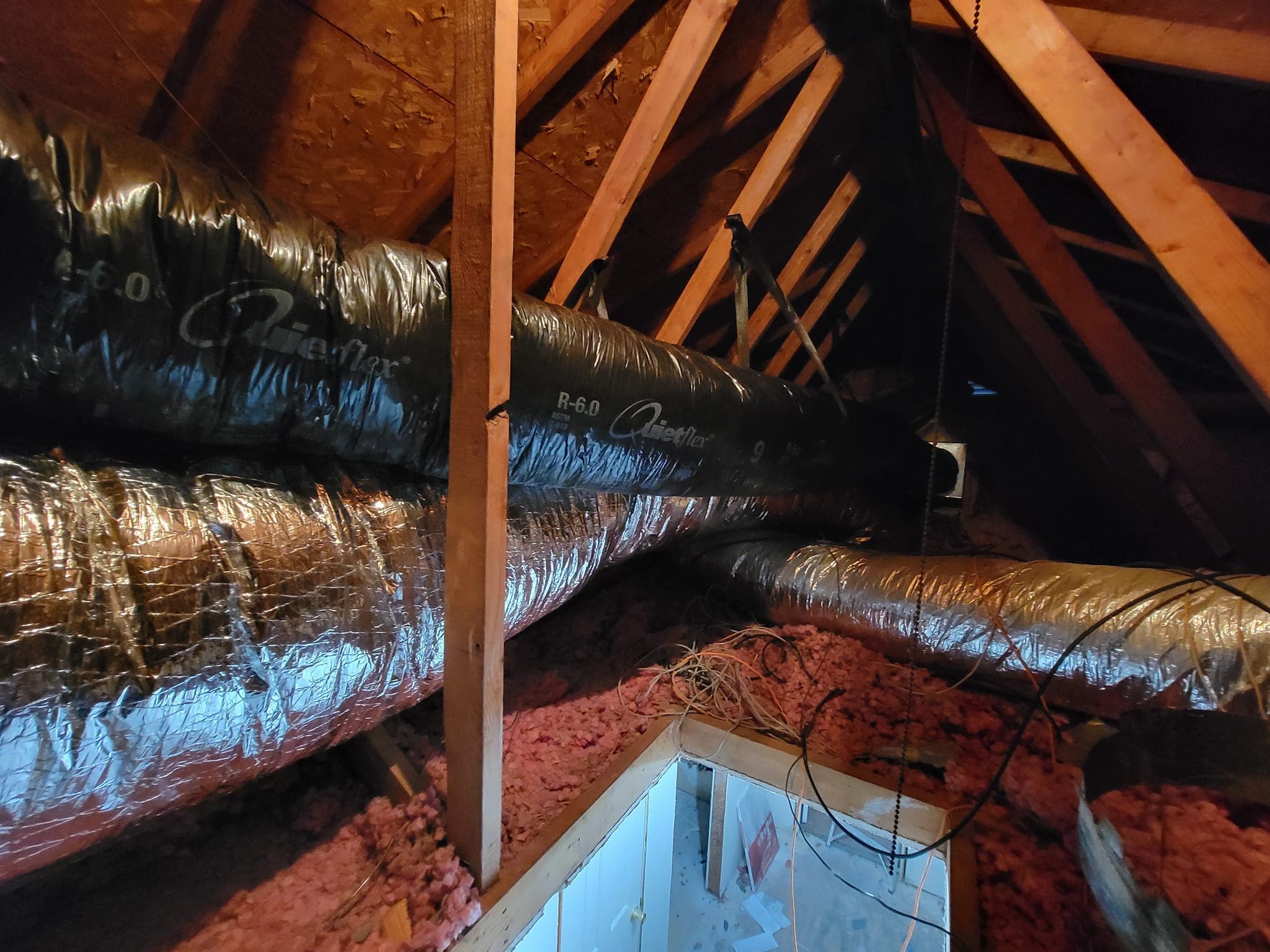 Insulated ductwork running through an attic in a Flower Mound home serviced by Frosty's HVAC
