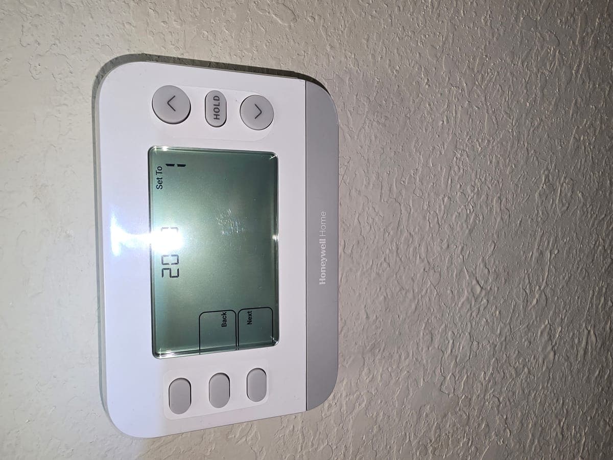 Honeywell thermostat installed on wall at a Farmers Branch home