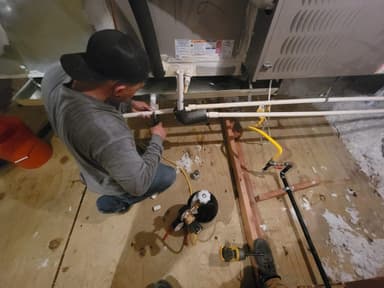 Omar Jacobo installing HVAC system in Texas attic — Frosty's HVAC Co-Owner & Lead HVAC Technician