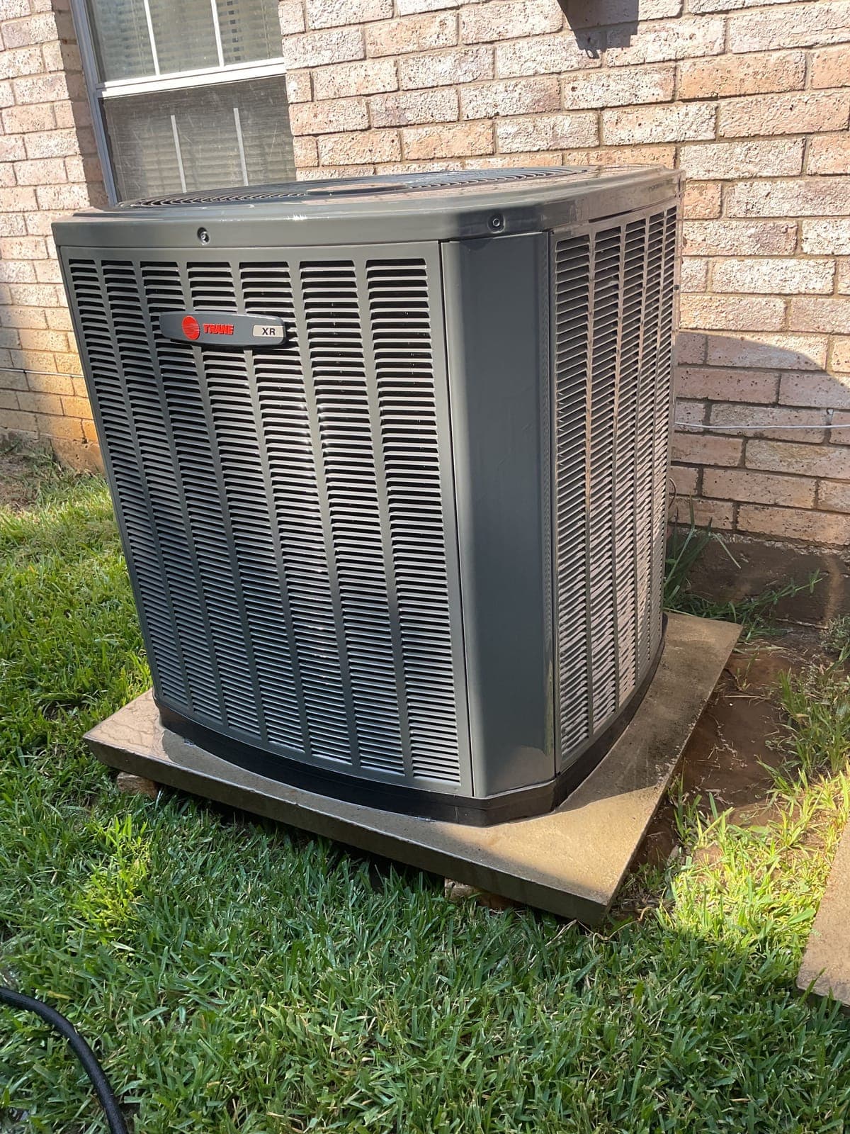 New Trane AC condenser installed at a brick home by Frosty's HVAC in Coppell TX